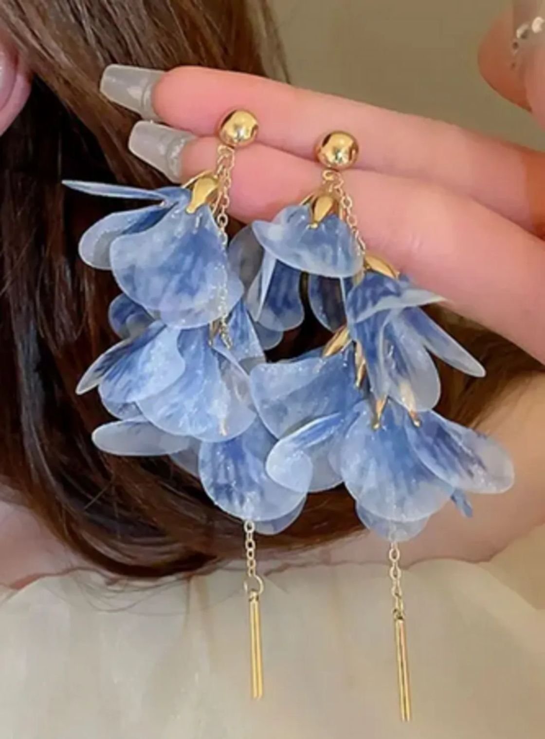 blue floral hanging earrings worn by woman stylish design