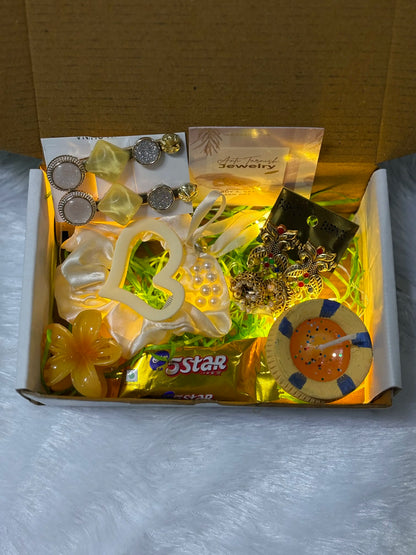 Festive gift hamper for women with earrings candle and accessories