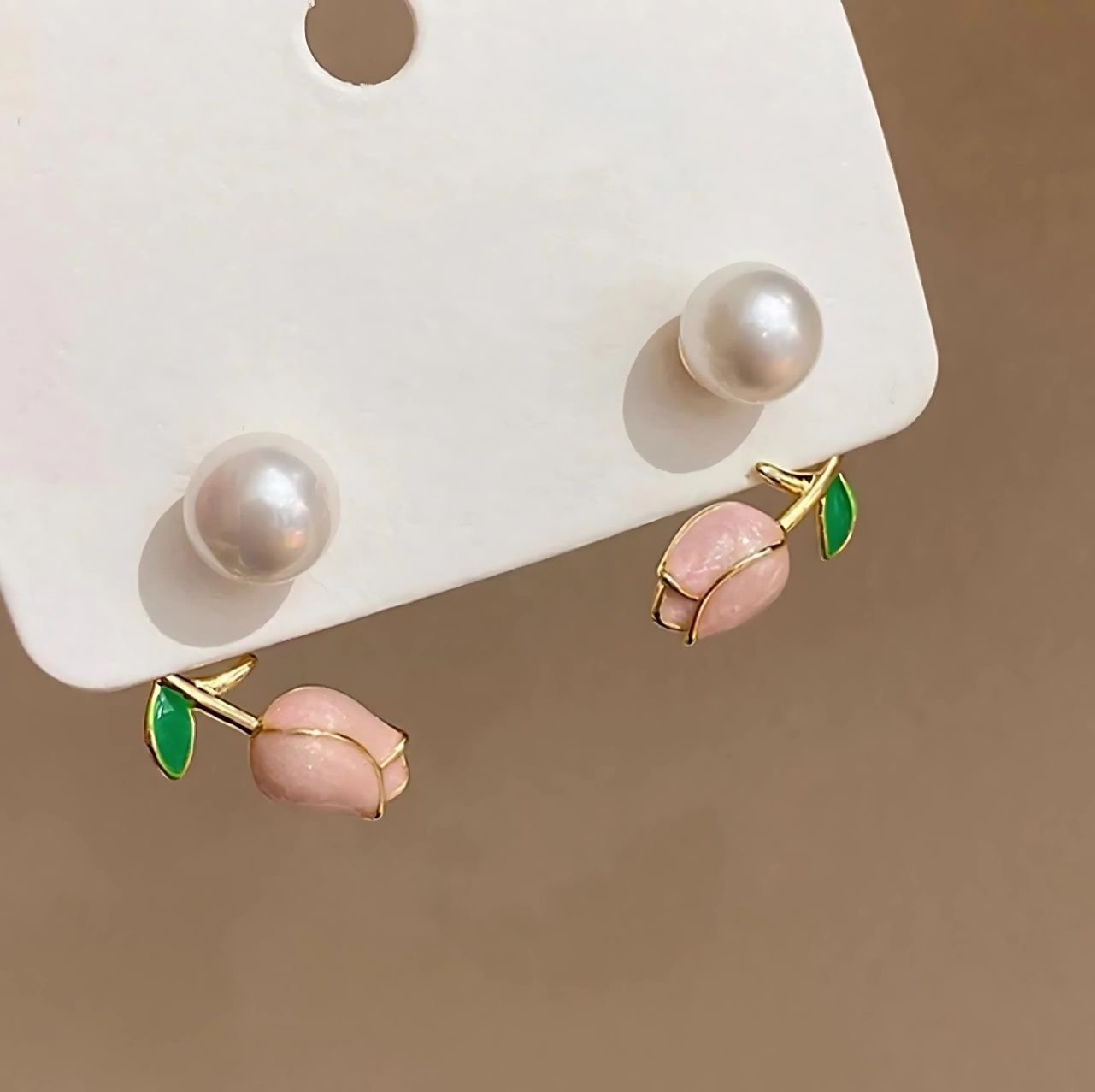 pearl floral stud earrings worn by woman elegant design