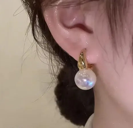 pearl drop earrings worn by woman elegant minimal jewelry