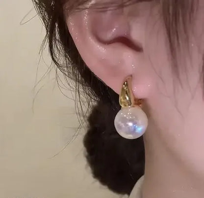 pearl drop earrings worn by woman elegant minimal jewelry