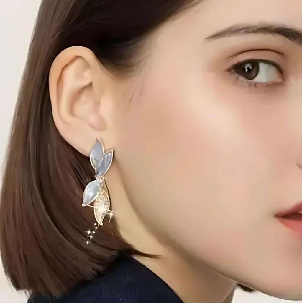 leaf shaped stud earrings worn by woman elegant style